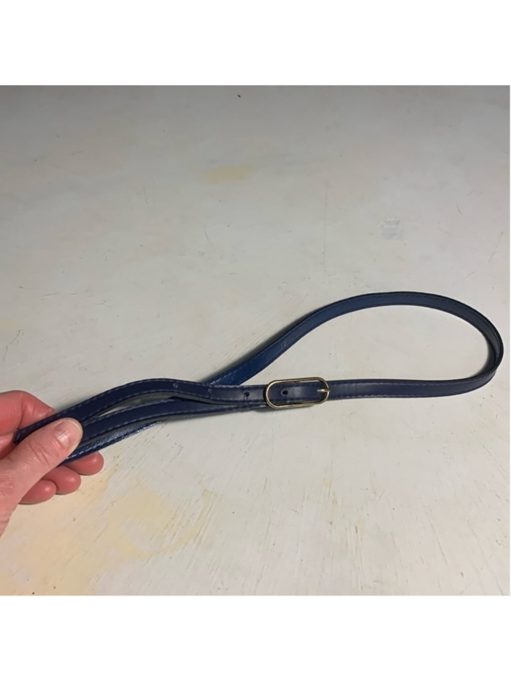 Thin blue belt with gold buckle